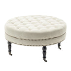 Pouf de cocktail rond en tissu Indy Porthos Home avec pieds et roulettes en bois d'hévéa