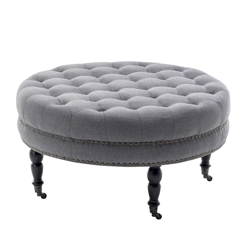 Pouf de cocktail rond en tissu Indy Porthos Home avec pieds et roulettes en bois d'hévéa