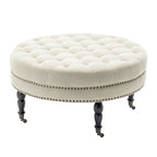 Pouf de cocktail rond en tissu Indy Porthos Home avec pieds et roulettes en bois d'hévéa