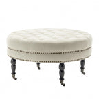 Pouf de cocktail rond en tissu Indy Porthos Home avec pieds et roulettes en bois d'hévéa